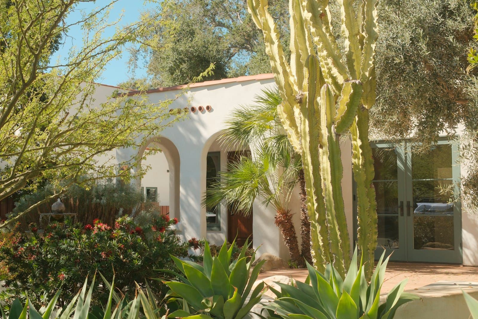 A white Spanish-style home with a drought-tolerant garden in Southern California sun